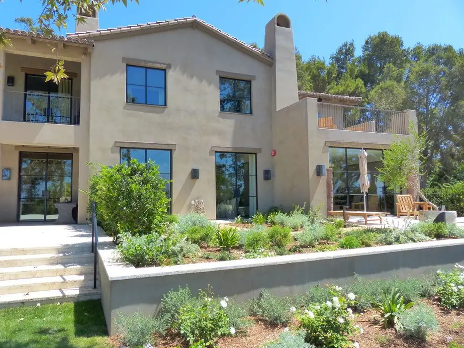 Black steel-framed doors and windows installed on a Southern California home