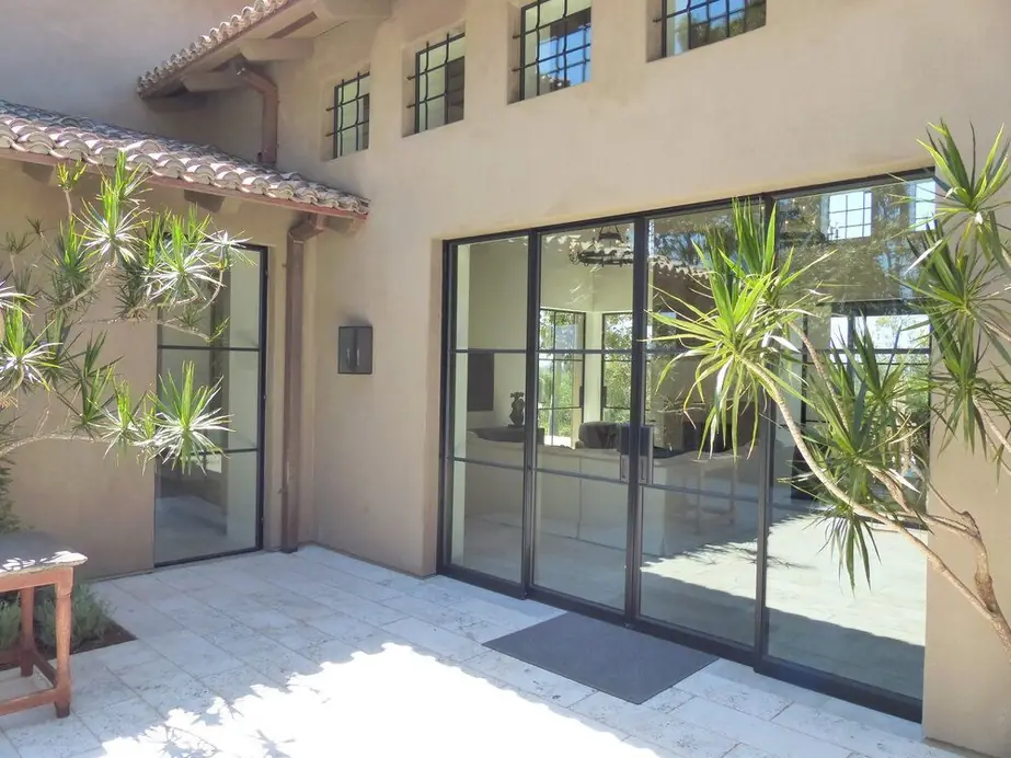 A black steel-framed door and window installation on a Southern California home, real work supplied by Builder's Window Supply