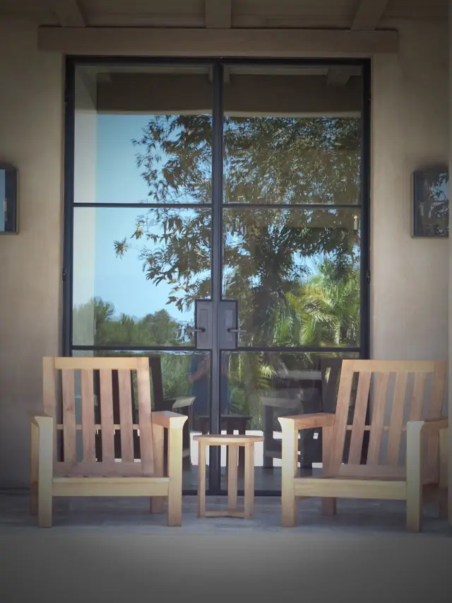 A black steel-framed door and window installation on a Southern California home