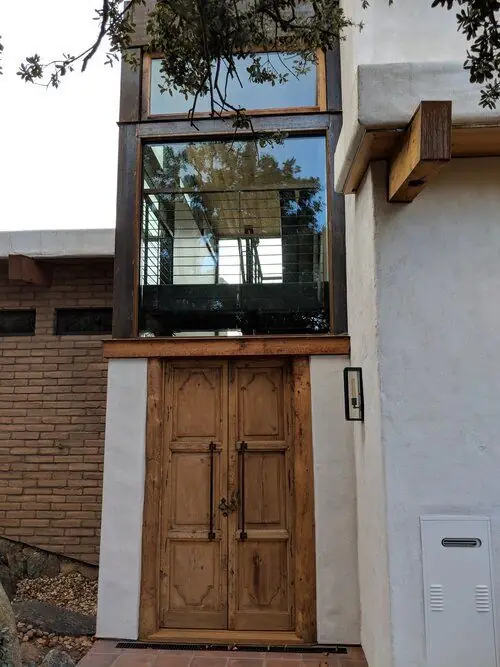 An antique-style wood double entry door with hand-forged iron hardware, a real Builder's Window Supply delivery.